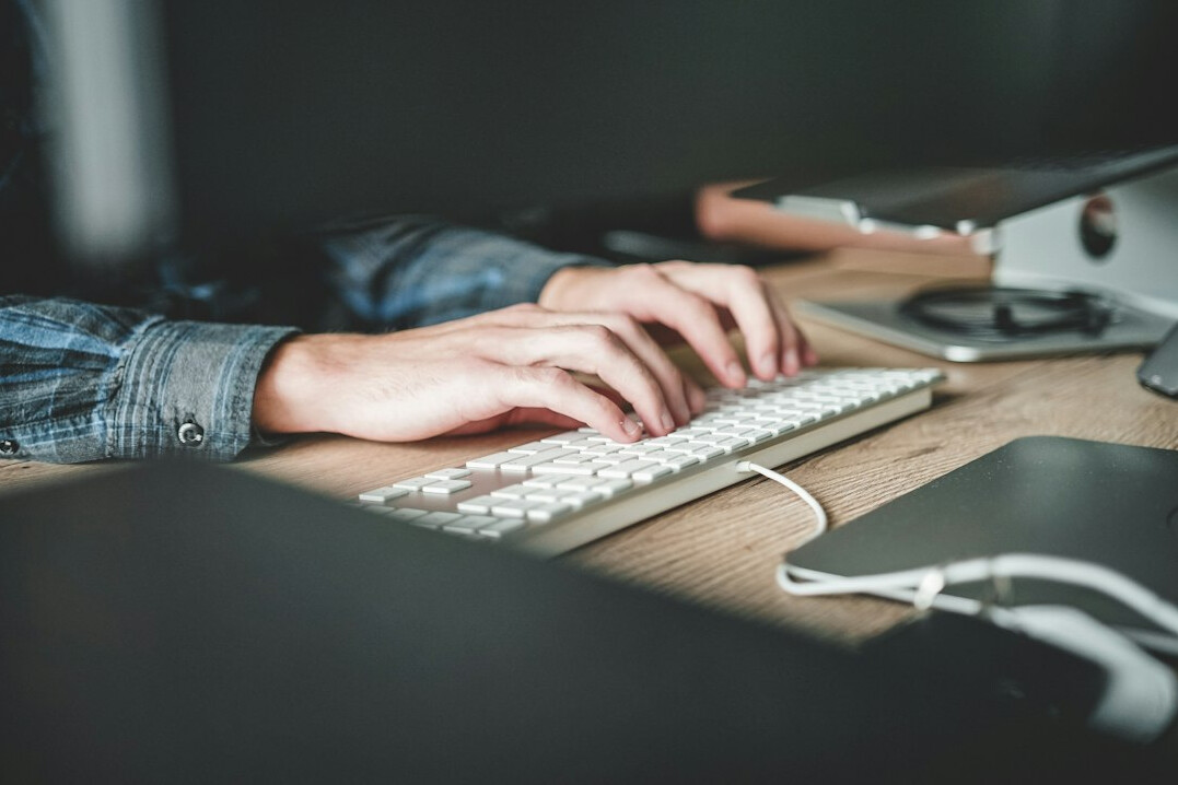 writer typing mystery novel at desk