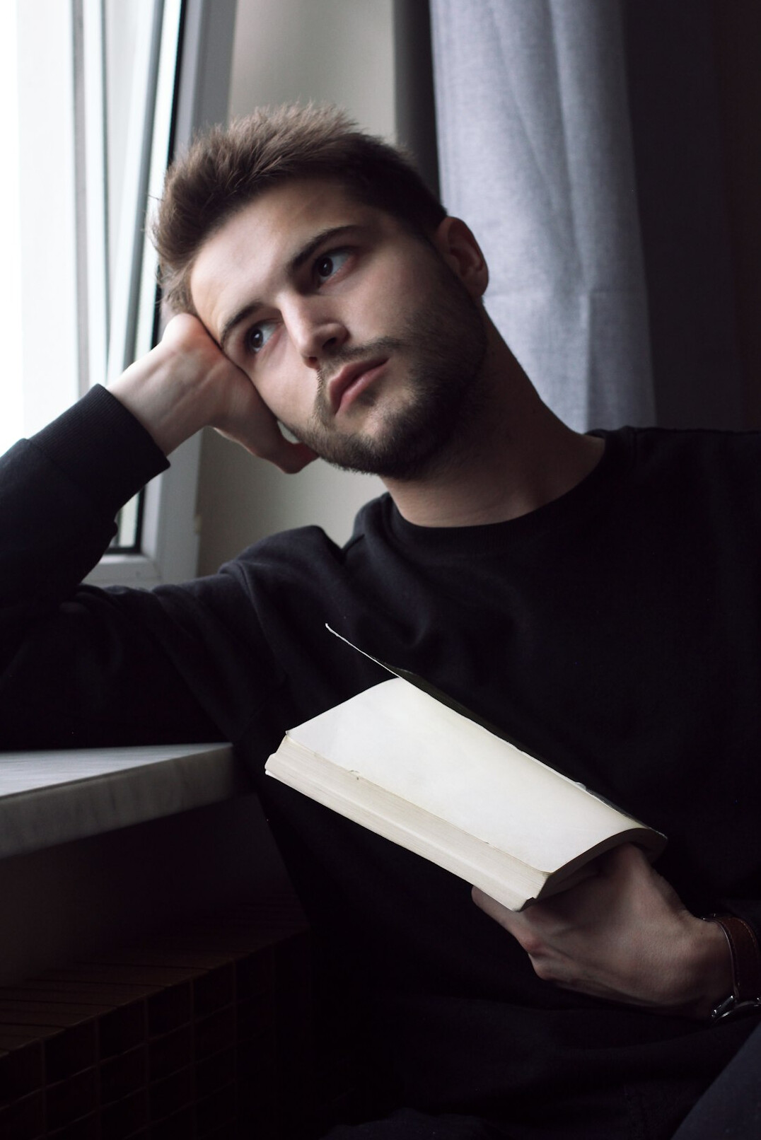 anxious reader holding book