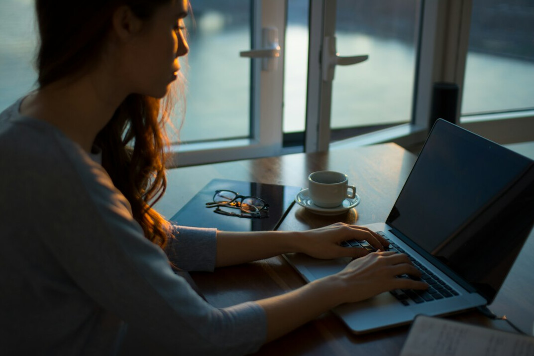 author typing on laptop
