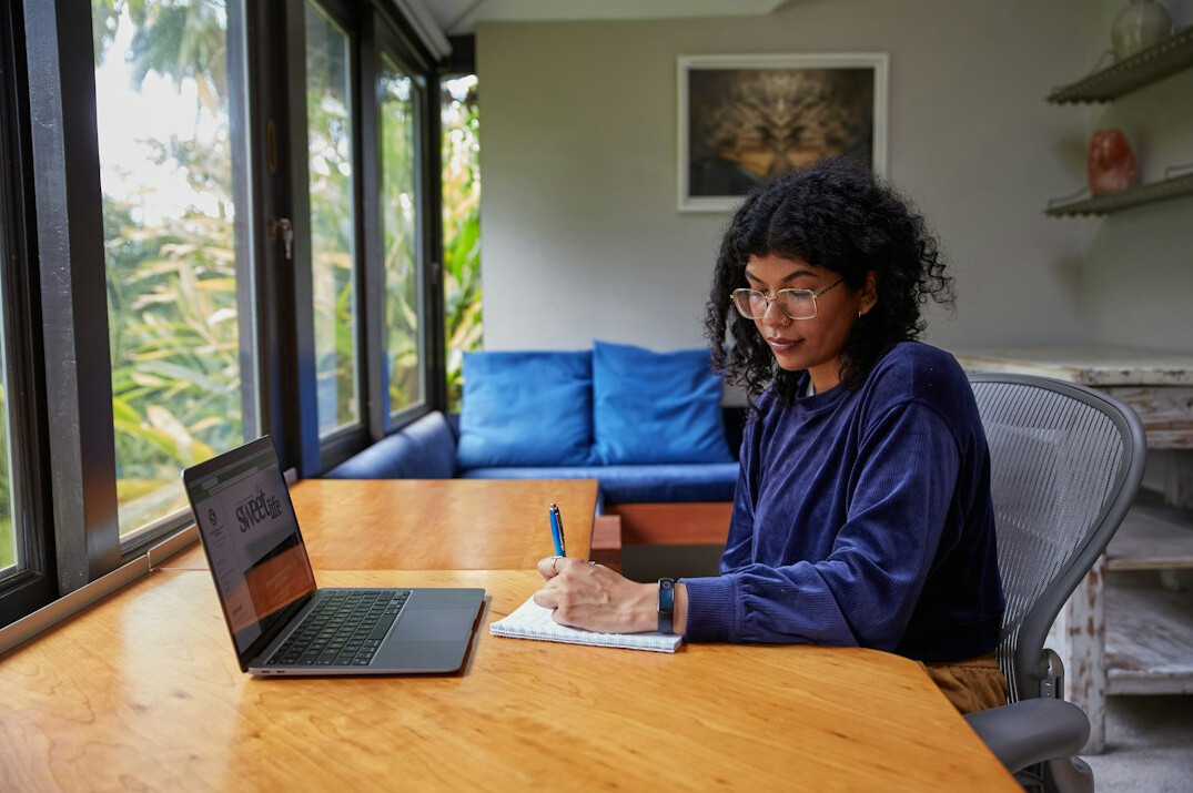 mystery writer at desk with notebook